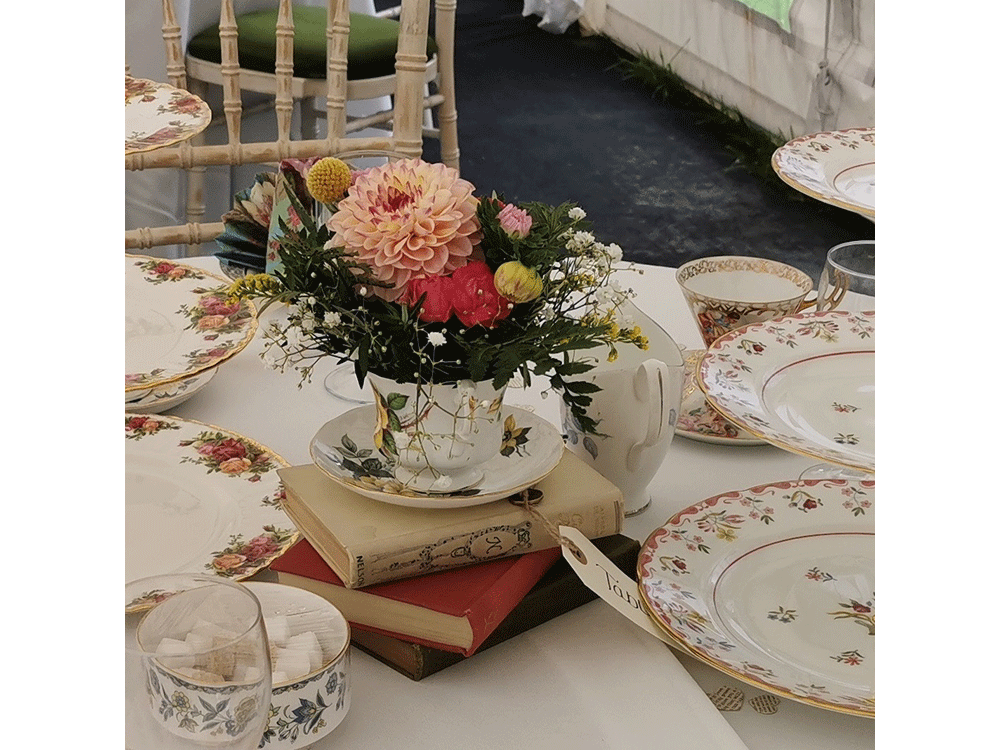 Round table set for wedding breakfast with vintage china