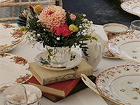 Round table set for wedding breakfast with vintage china